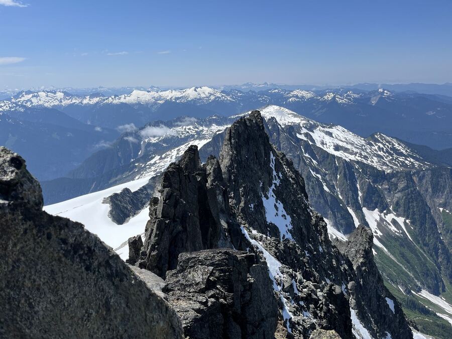 A dark rock spire rising from snowy ridges